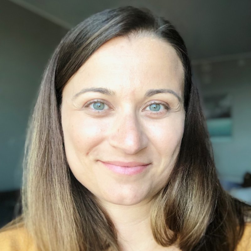 Dr. Annette Mazevski, audiologist, smiling, with shoulder-length brown hair